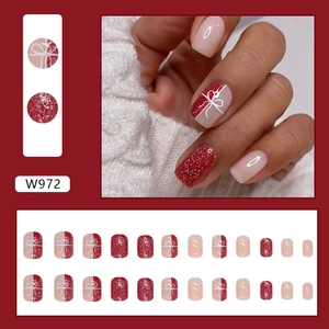 Festive red glitter press-on nails set with elegant white bow pattern, 24 piece kit