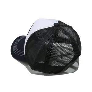 Detail view of tri-color trucker hat featuring breathable mesh and curved brim stitching