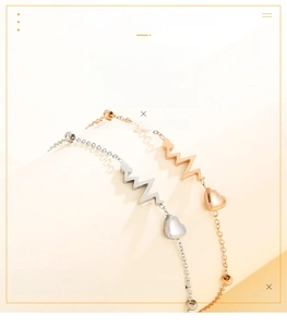 Detailed view of stainless steel heartbeat and heart charm bracelets in silver and rose gold