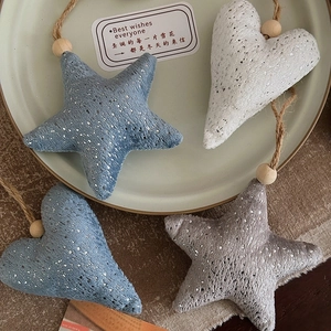 Hanging Christmas ornaments with heart and star shapes in blue and grey knit fabric