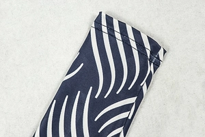 Detailed view of striped athletic fabric showing precise double-needle stitching on cuff