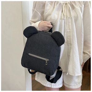 Detail of dark grey denim mini backpack with cute bear ears and silver zipper accents