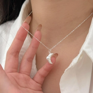 Elegant 925 sterling silver croissant necklace worn on a white shirt minimalist style