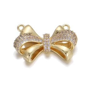 Detailed view of a gold bow pendant charm with sparkling rhinestones and dual link loops