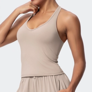 Close-up of khaki V-neck sports bra featuring slim fit cut and moisture-wicking fabric