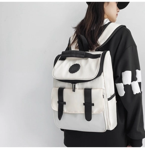 Back view of a white nylon backpack with black contrast straps and buckled front pockets