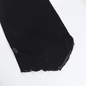 Detailed close-up showing wave-hem edge and black mesh texture on the dress