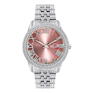 Detail of pink Roman numeral dial with iced-out diamond bezel and date window on watch