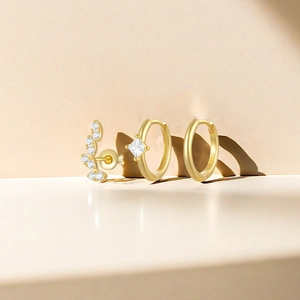 Detail of S925 gold-plated earring set featuring leaf studs and zircon hoop earrings