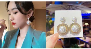 Detailed macro view of 925 silver pearl earrings with rhinestones on model and card