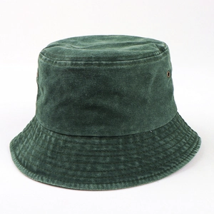 Detail of dark green washed cotton bucket hat with metal eyelets and stitched brim