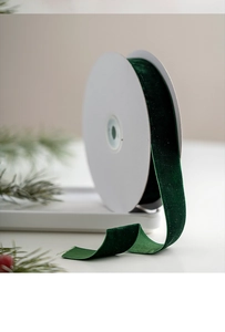 Detail of dark green velvet ribbon roll for Christmas gift wrapping and DIY crafts