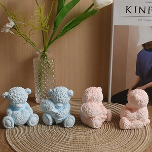 Detailed texture of teddy bear scented candle molds in soft pink and blue pastel colors