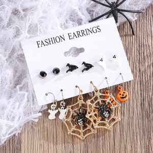 Detailed set of Halloween earrings featuring ghost, pumpkin, and spider web on a display card