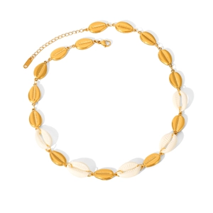 Detailed close-up of gold chain necklace with white and gold shell charms and K18 tag
