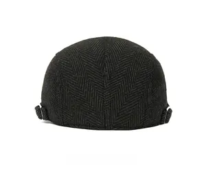 Rear view of herringbone newsboy cap showing adjustable metal side buckles and wool texture