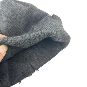 Detailed view of dark grey ribbed knit beanie showing fabric texture and thick hem