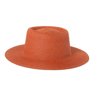 Detailed close-up showing the fine texture of the orange straw sun hat with flat top