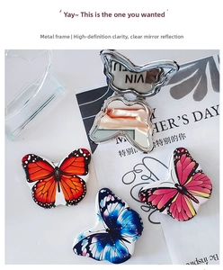 Close-up of butterfly-shaped folding makeup mirror with colorful patterns and metal frame