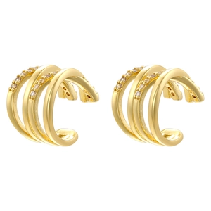 Macro shot of tiered gold C-shaped ear cuffs with zircon stones and polished finish