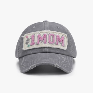 Close-up of distressed dark grey baseball cap featuring pink #1 MOM chenille embroidery