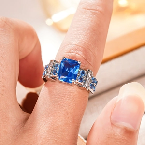 Macro shot of a rectangular blue sapphire ring with micro-pave silver settings