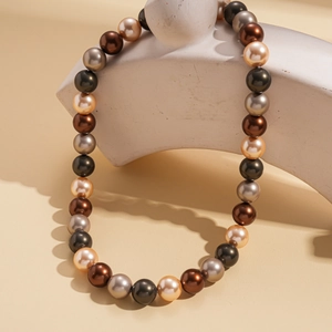 Détail d'un collier de perles bohème avec perles dégradées sur support géométrique