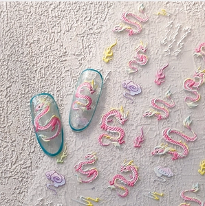 Detail of pink cartoon dragon nail stickers with traditional cloud and flame patterns