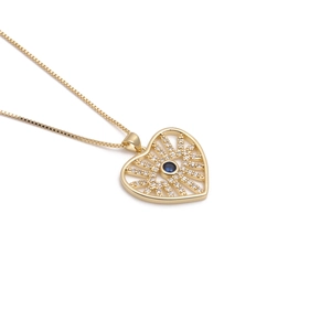 Golden heart necklace with blue evil eye pendant and zircon crystals on white background