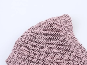 Close-up of the delicate crochet texture and mauve knit fabric on this elegant summer set