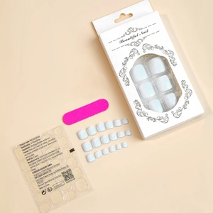 Kit featuring white pearl press-on toenails, adhesive stickers, and a pink mini nail file