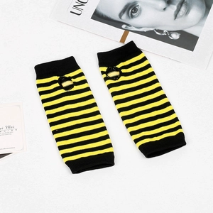 Detail of yellow and black striped knitted fingerless arm sleeves with thumb hole