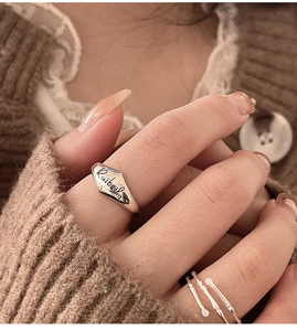 Macro detail of silver S925 bamboo rings featuring Ruibeila engraving and braided band