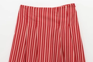 Detailed view of red and white vertical striped fabric on a midi skirt waistline
