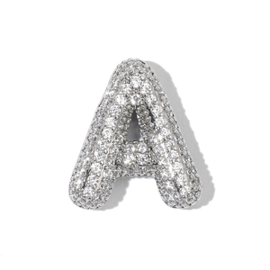 Macro shot of silver-plated letter A pendant featuring micro-pave cubic zirconia stones