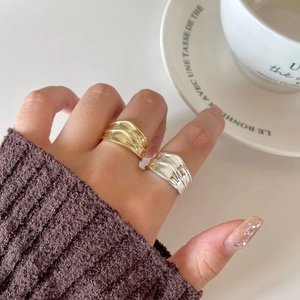 Irregular wavy wide 925 silver rings in gold and silver finish on hand