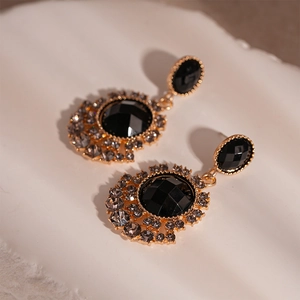 Vintage gold sunflower earrings with black faceted gemstones and grey rhinestones