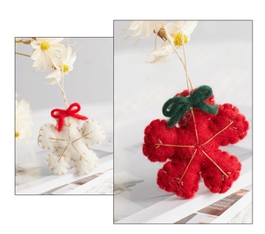 Detailed texture of red and white handmade felt flowers with golden stitch and bow