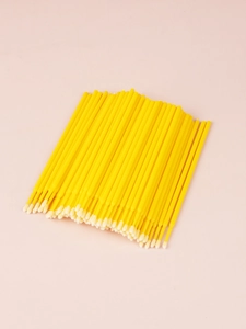 Macro view of disposable micro applicators with yellow handles and white fiber tips