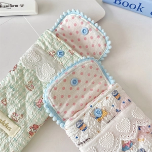 Detailed close-up of quilted padded eyewear pouch with cute patterns and snap button