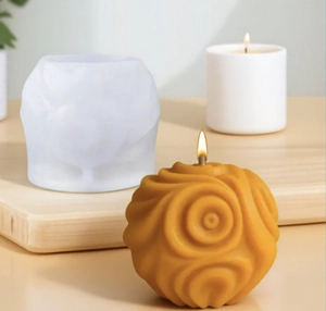 Detail of round spiral silicone mold with finished yellow textured sphere candle