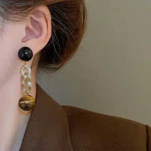 Elegant silver needle drop earrings with amber links and tiger eye stone beads
