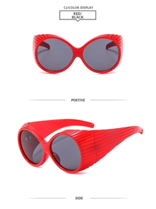 Front and side view of red oversized Y2K sunglasses with dark lenses and striped texture