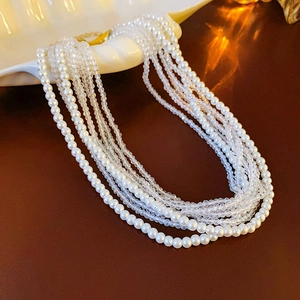 Detail view of multi-layer bohemian necklace with white pearls and sparkling crystal beads