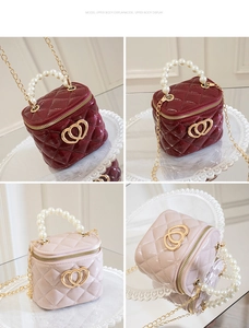 Detail of mini quilted jelly bag with pearl handle, gold chain and double heart logo