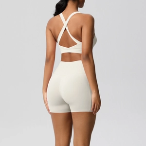 Detail of cross-back yoga bra and high-waisted shorts in creamy white athletic set