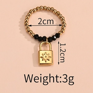 Detail view of elastic bead ring with gold star padlock charm and size measurements