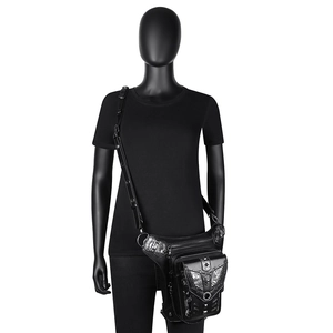 Detail of gothic punk PU leather thigh bag with skull embossing and silver metal studs
