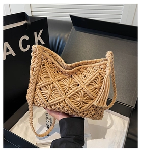 Detail of handmade woven bag with tassels, metallic zipper and woven cotton rope strap