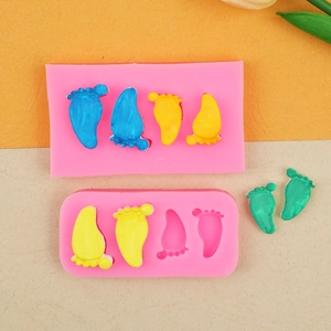 Vue détaillée du moule en silicone rose avec empreintes de bébé et argile colorée